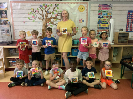 Photo of students with their art work